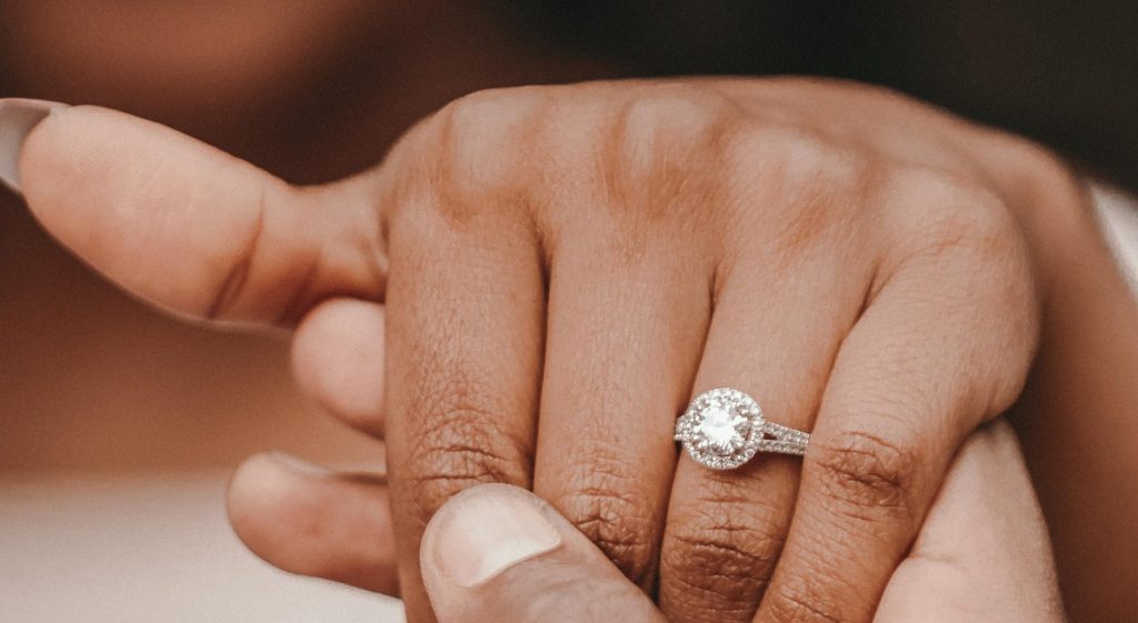 African American woman's hand showing an engagement ring