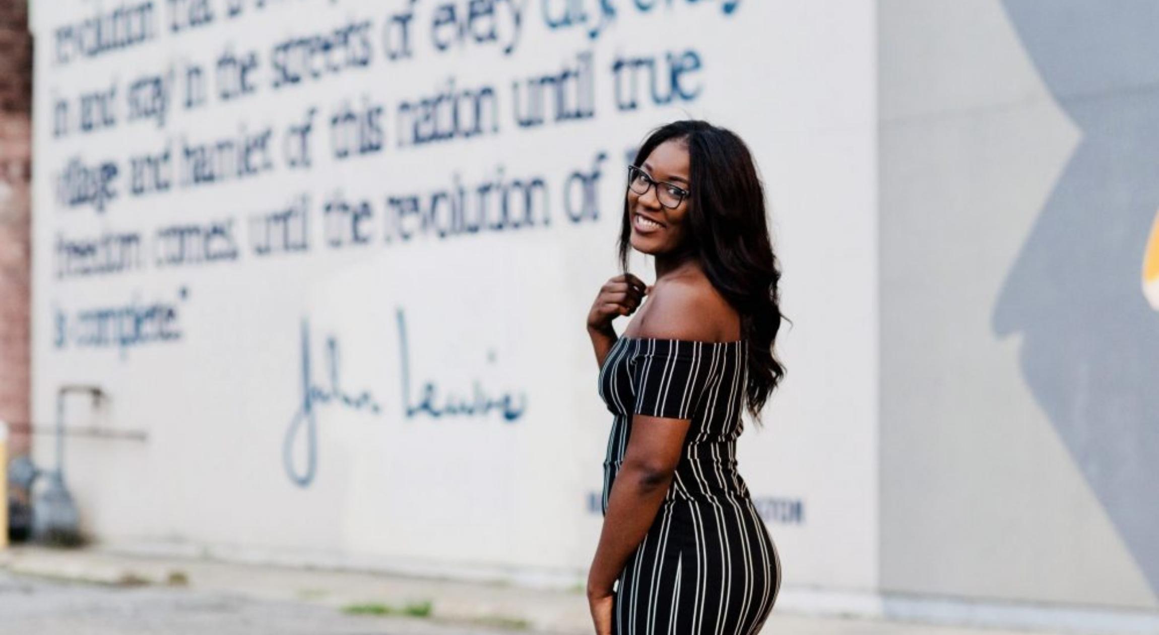 A Black woman looking at the camera