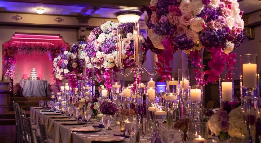 Purple and pink florals on a wedding reception table
