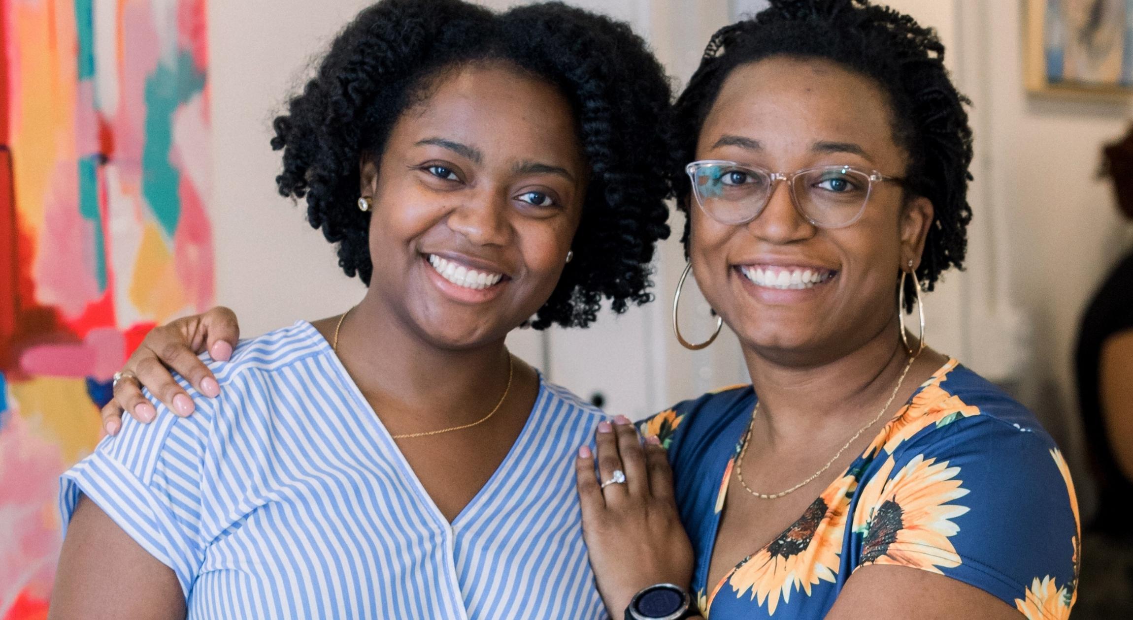 Two Black women smiling