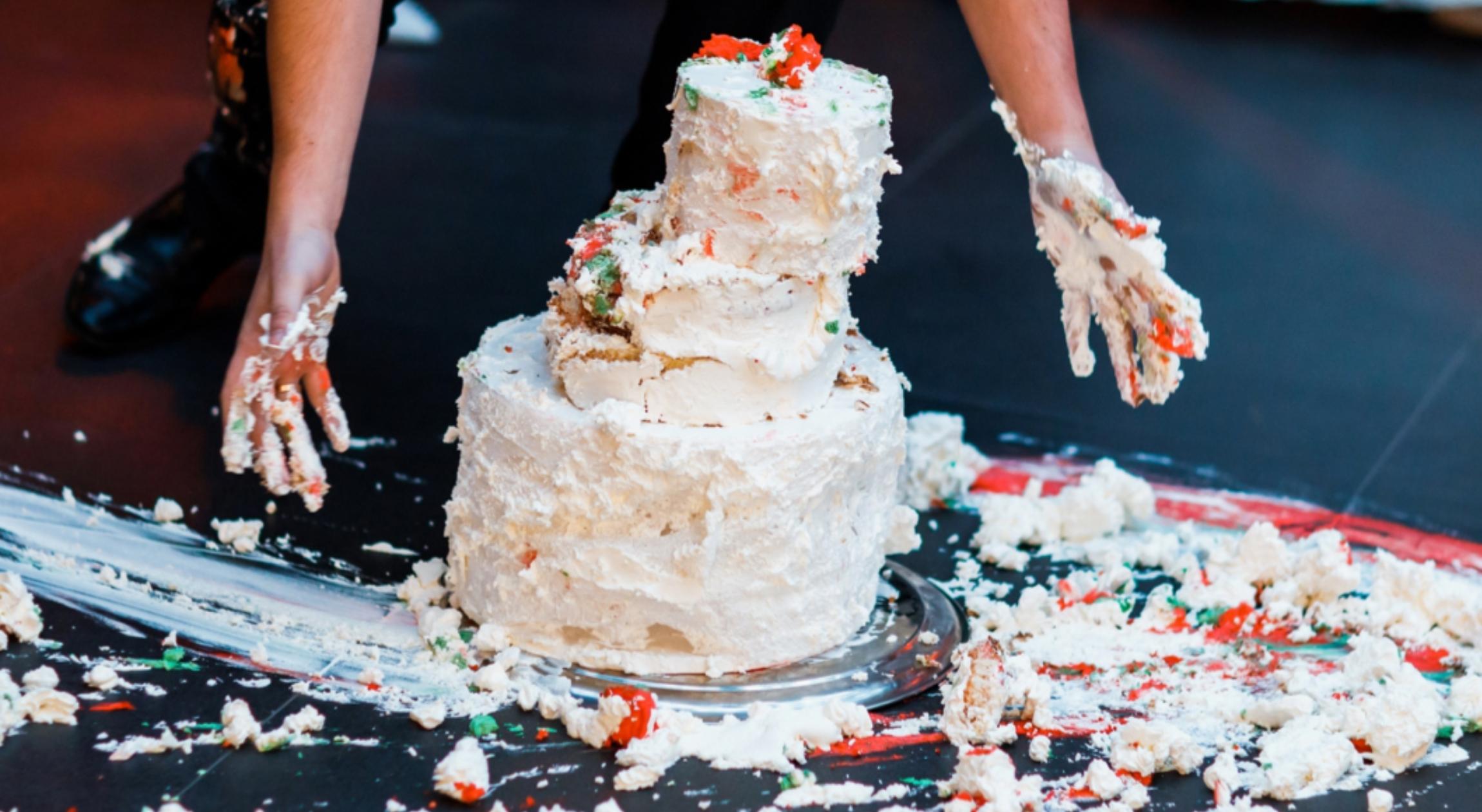 A dropped cake that is on the floor