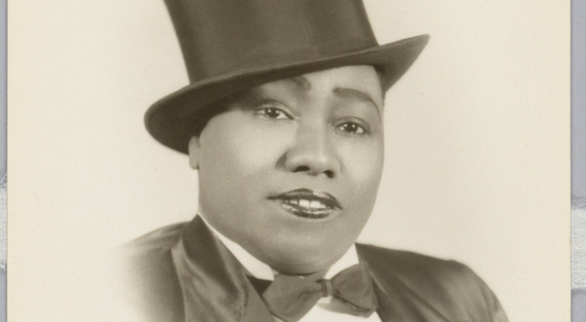 an old black and white photo of a person in a top hat