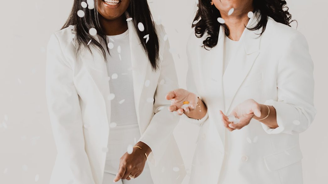 Two women in white suits.