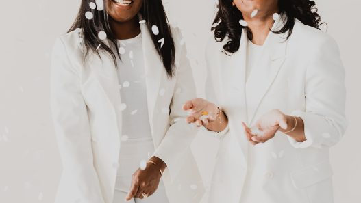 Two women in white suits.