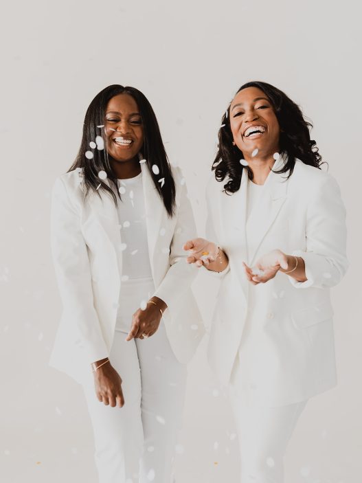 Two women in white suits.