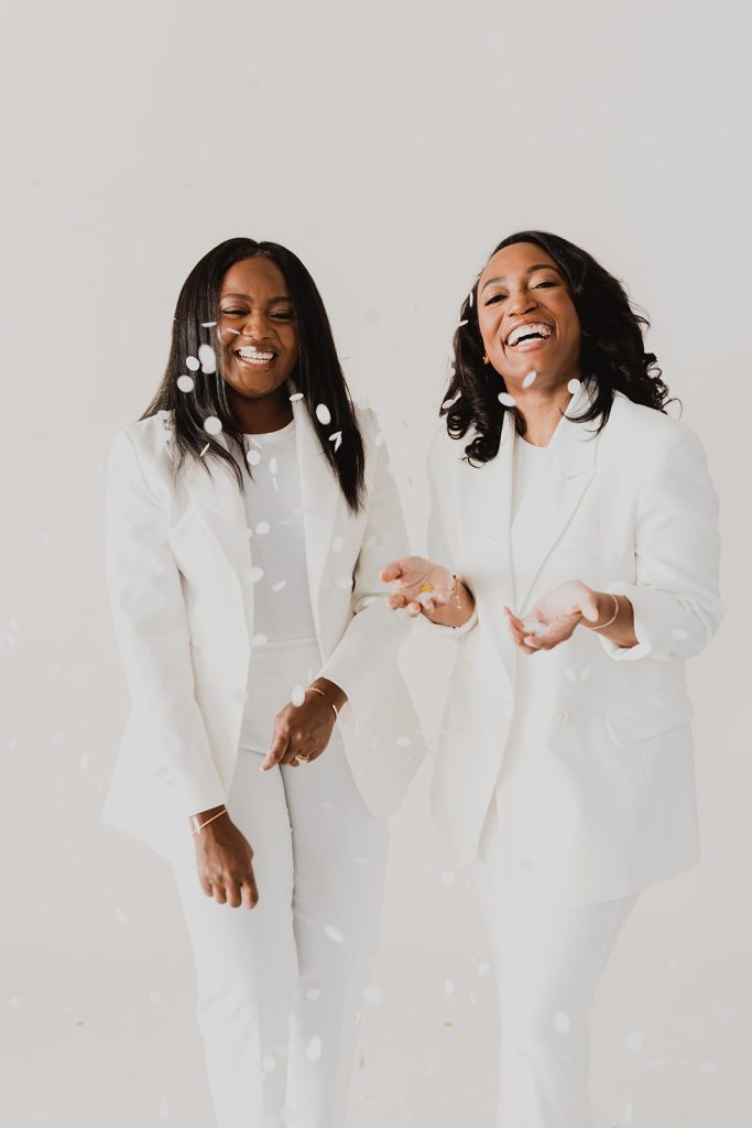 Two women in white suits.