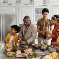 A family in the kitchen preparing food