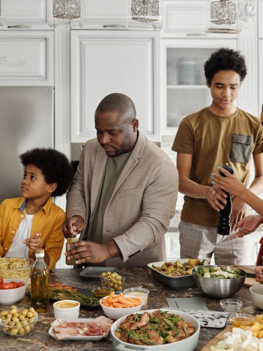 A family in the kitchen preparing food