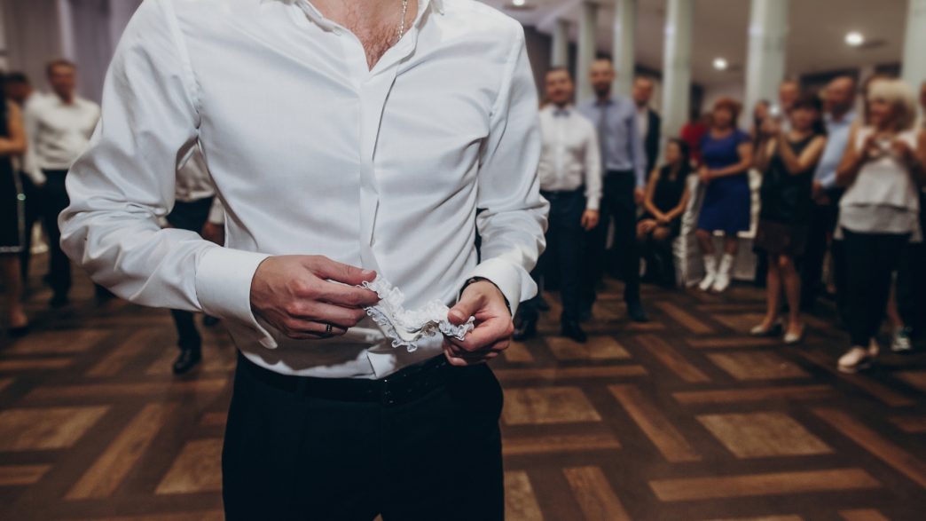 a person in a white shirt standing on a dance floor