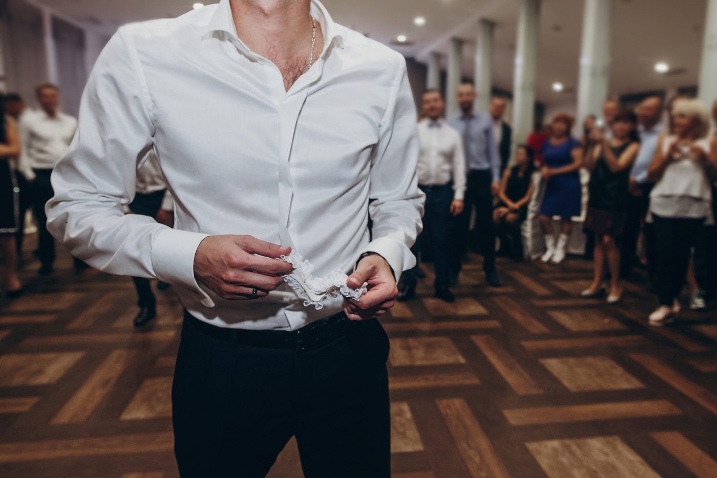 a person in a white shirt standing on a dance floor