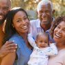 A Black family is smiling and posing for the camera.