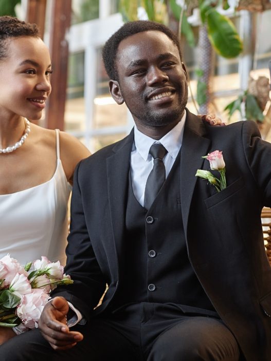 A Black couple taking a selfie at their wedding.
