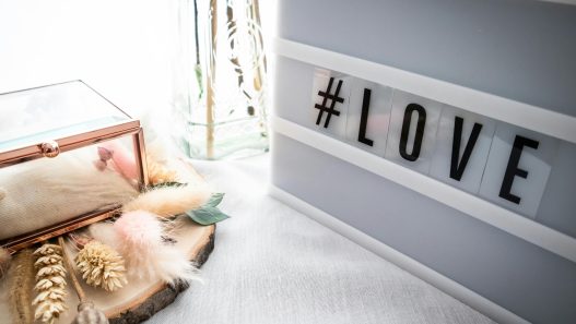 a light box with the word love on it sits on top of a white table