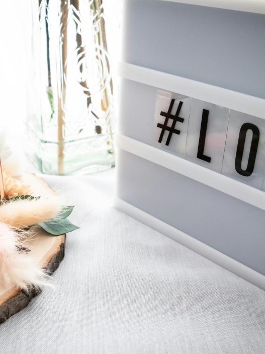 a light box with the word love on it sits on top of a white table