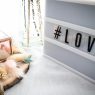a light box with the word love on it sits on top of a white table