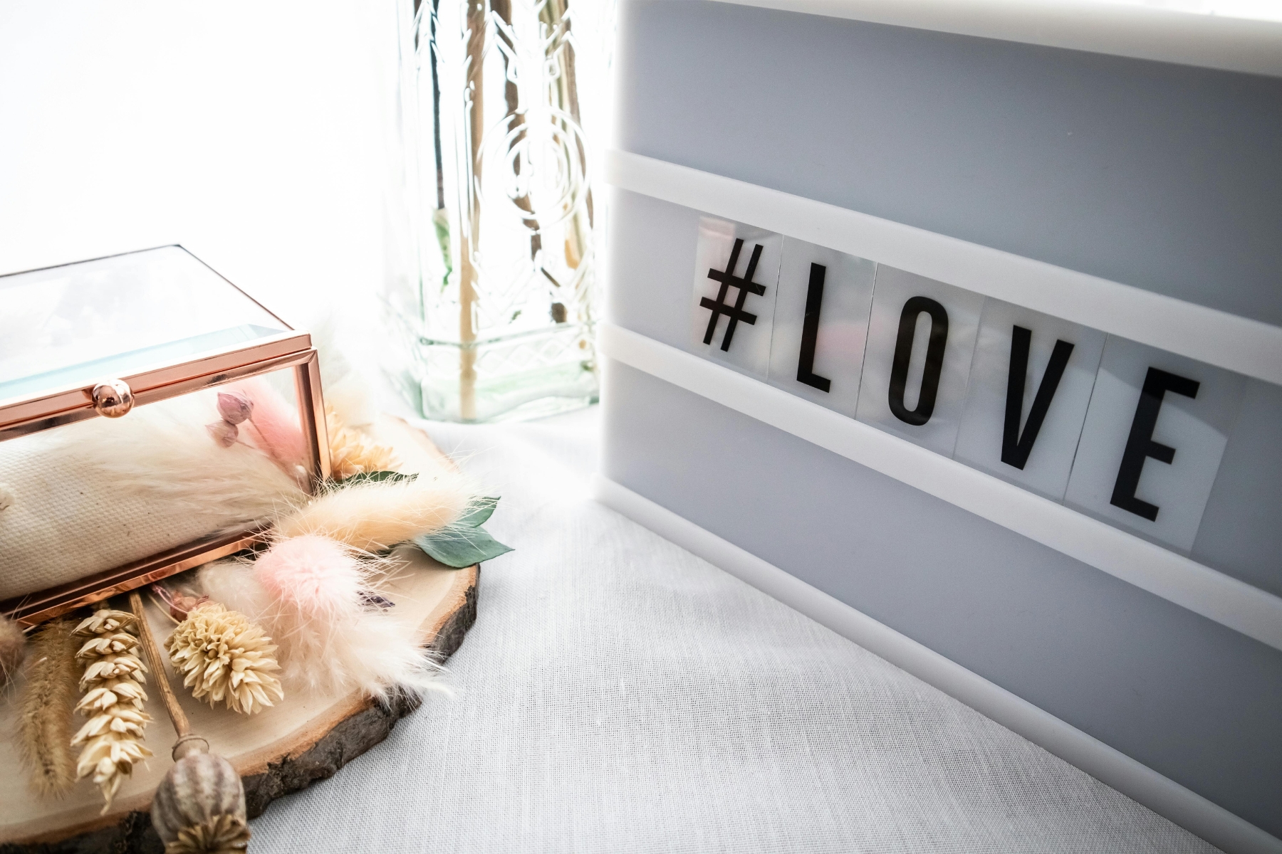 a light box with the word love on it sits on top of a white table
