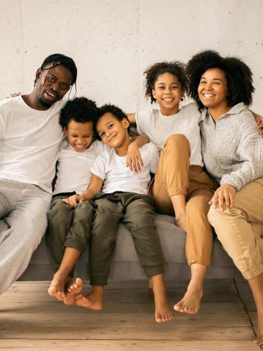 A family sitting on a couch in their living room