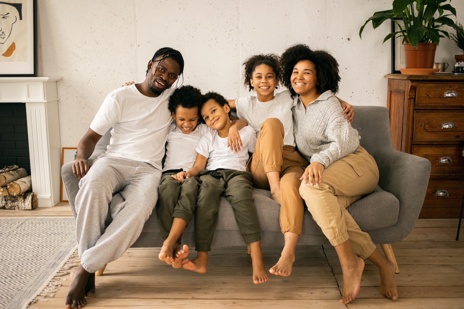 A family sitting on a couch in their living room