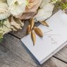 wedding cards and bouquet on a wooden table