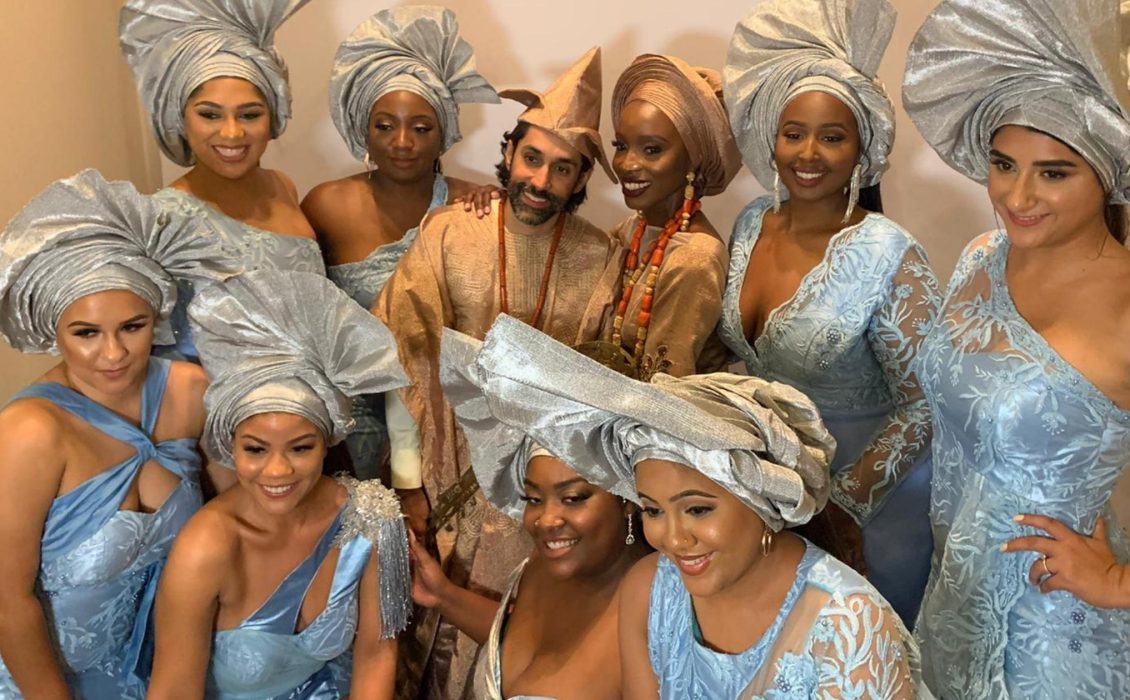 A Hindu husband and Nigerian wife with their bridesmaids in Nigerian attire