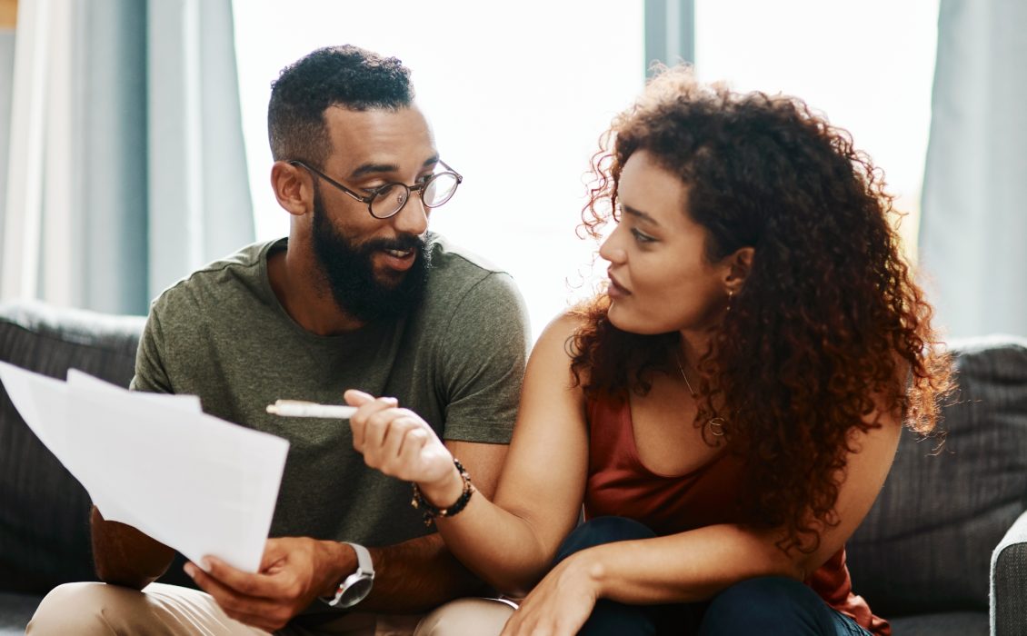 A brown couple looks at each other