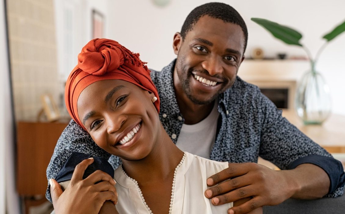 A Black couple smiles